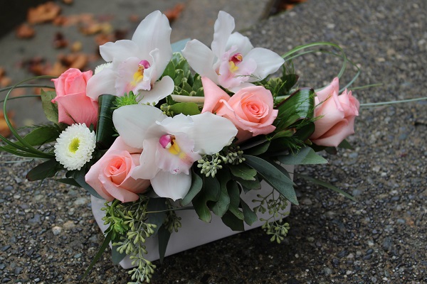 Small basket of white and pink flowers